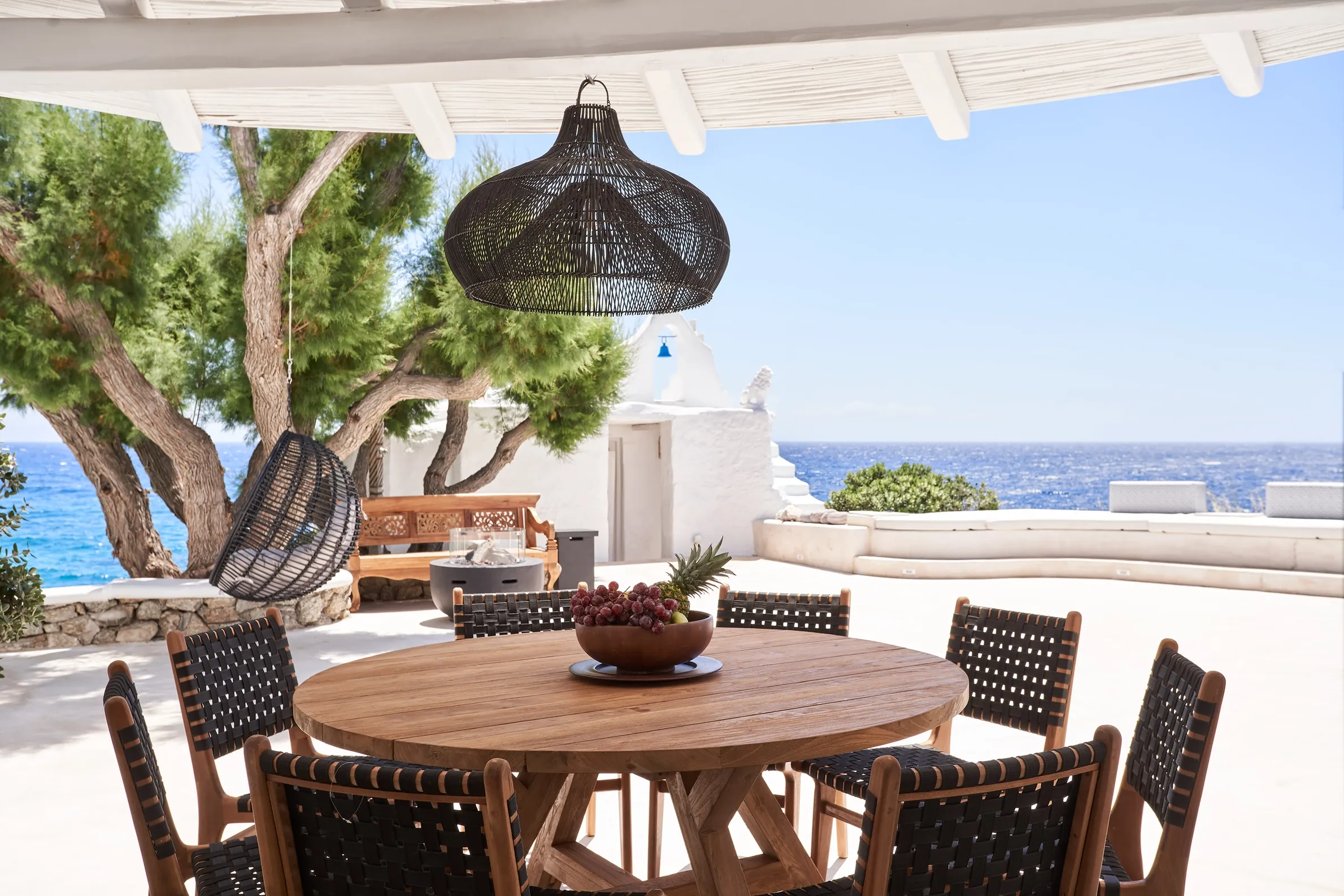 Terrace dining area beside the villa chapel overlooking the Aegean Sea