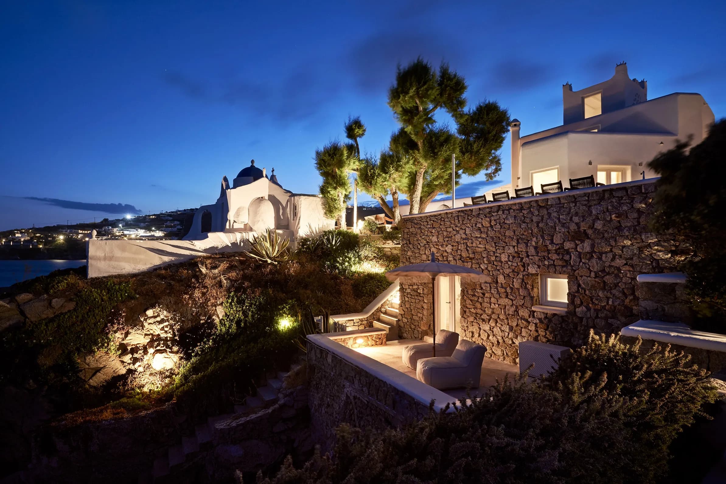 Santa Katerina villa, chapel and stone-walled garden lit up at dusk