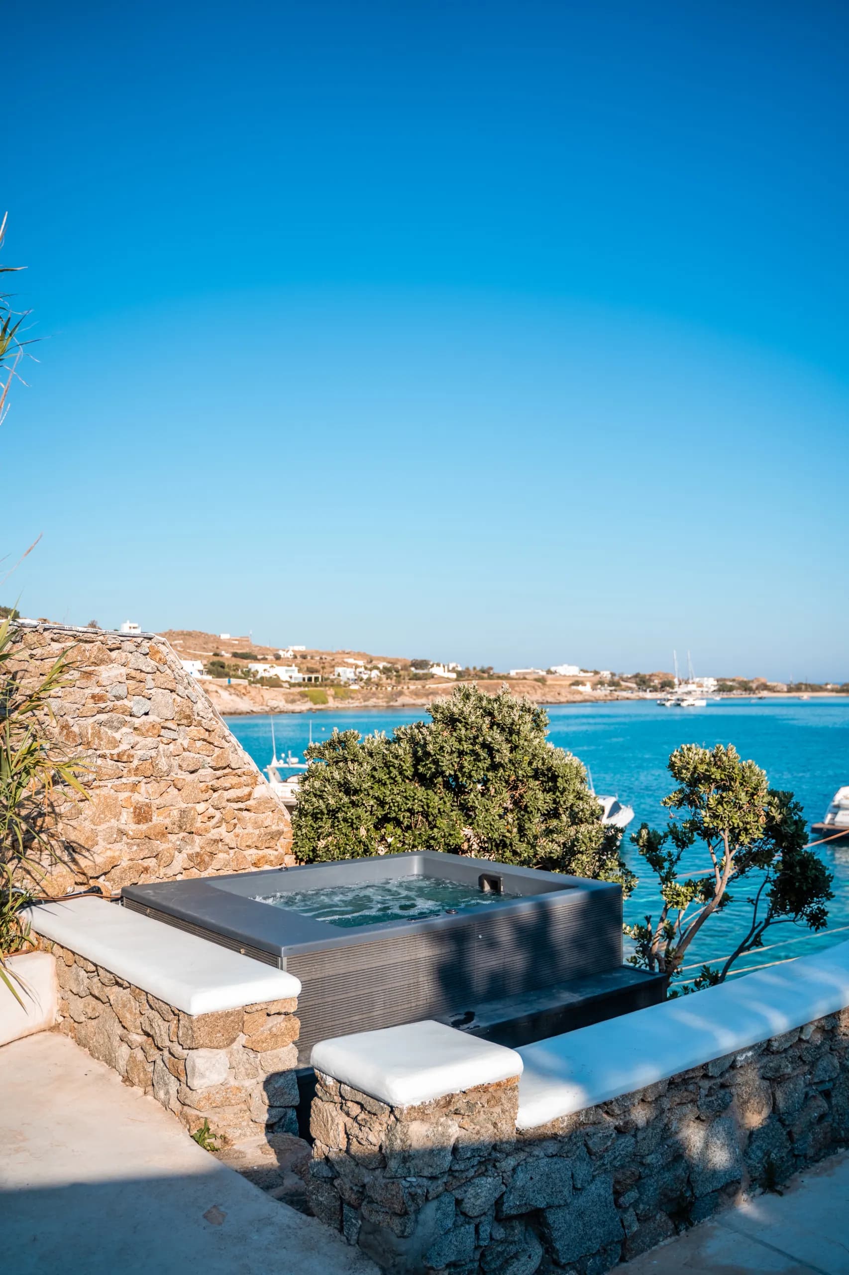 External jacuzzi on the terrace overlooking the turquoise bay